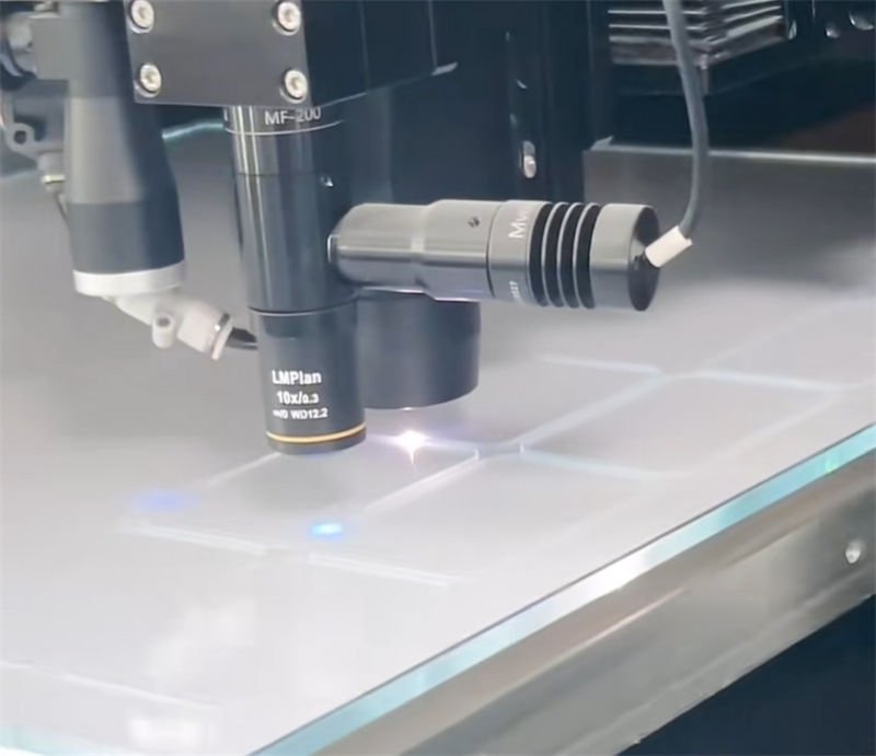 Close-up of a laser cutting machine focusing on a glass surface
