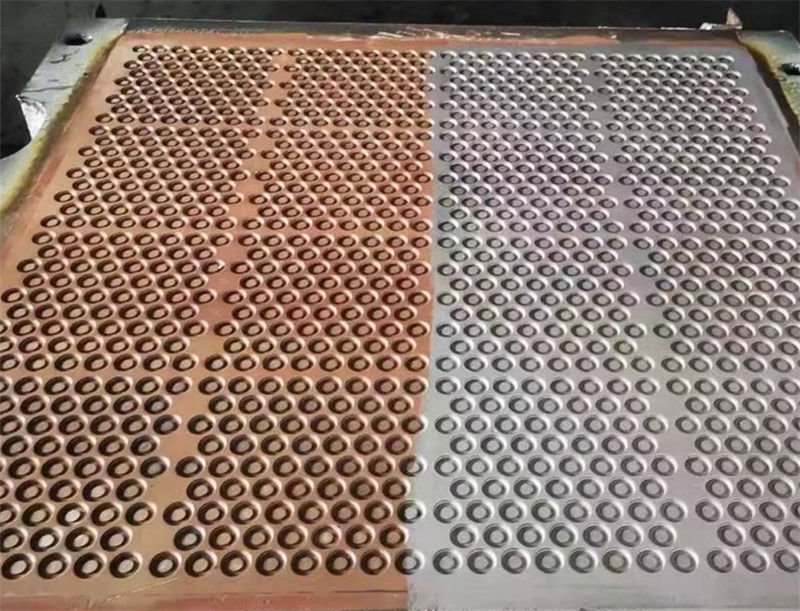 A tray of metal washers before and after laser rust removal