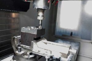 A CNC milling machine cutting a block of metal in a precision workshop