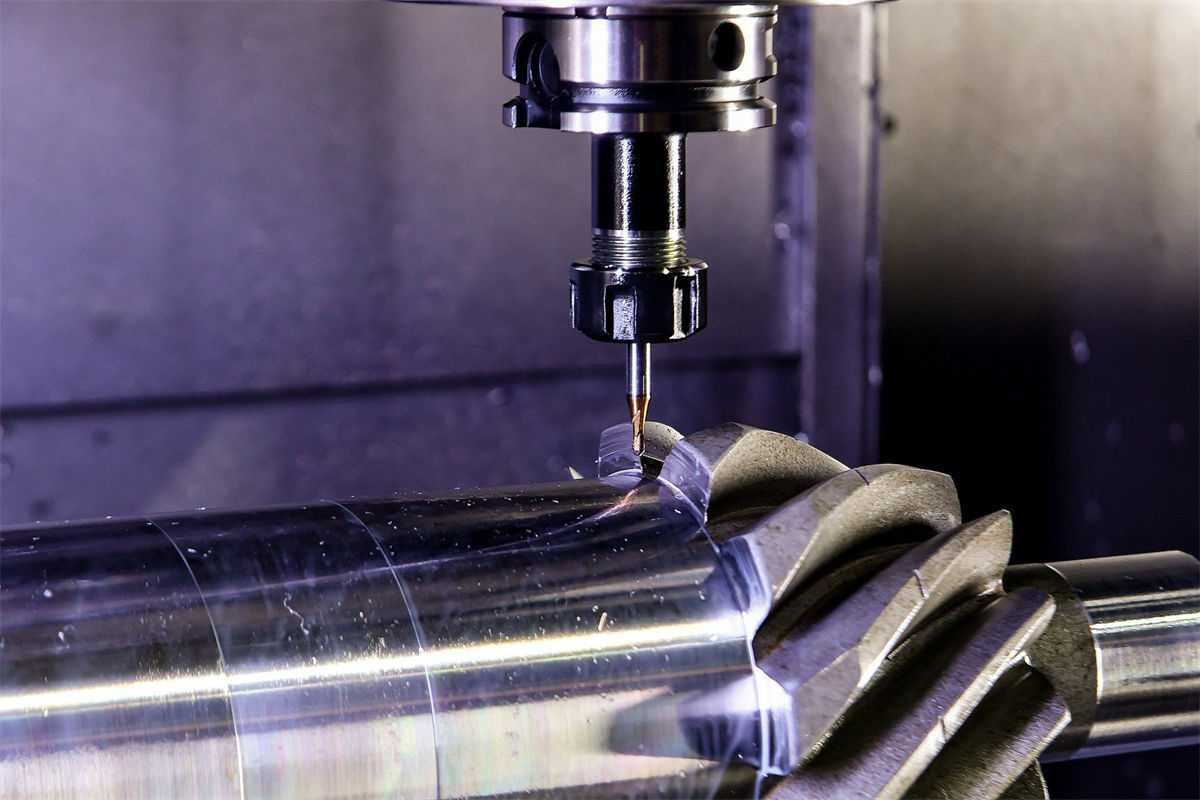 A CNC milling machine machining a precision gear on a cylindrical bearing shaft