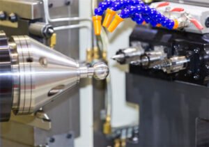 CNC lathe machine forming a metallic ball shape.