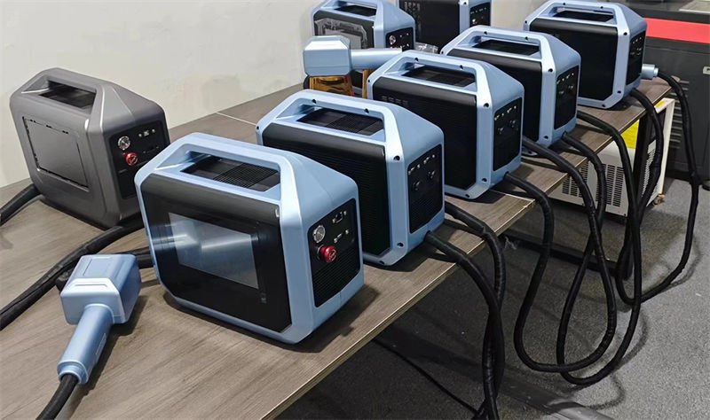 A collection of handheld laser marking machines lined up on a table