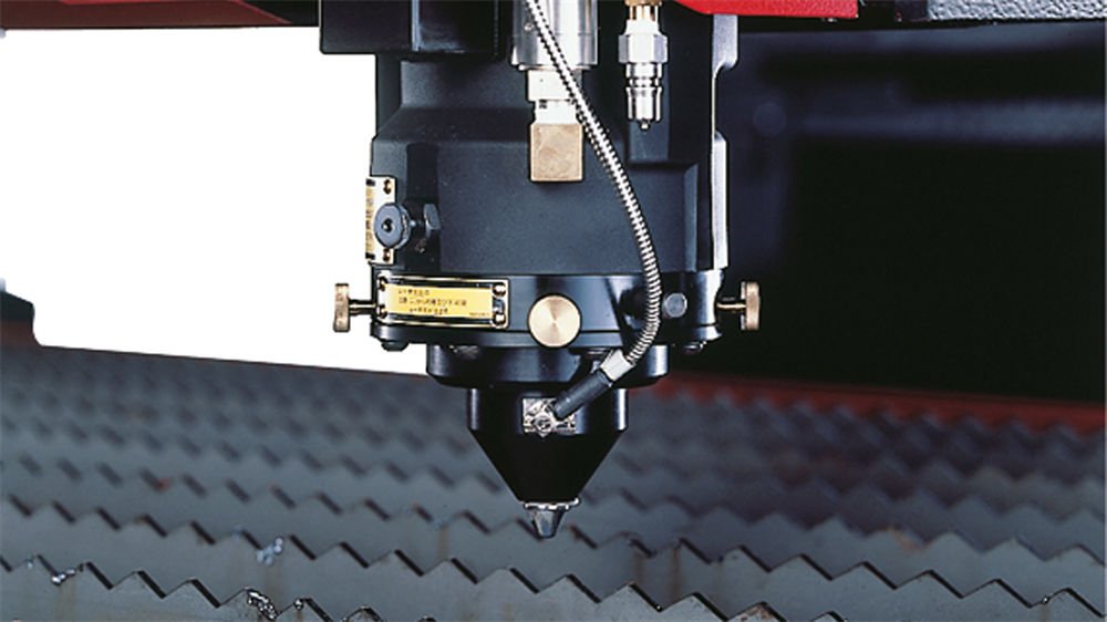 Close-up of the Amada FO-3015 laser cutting head, designed for precision and high-performance cutting
