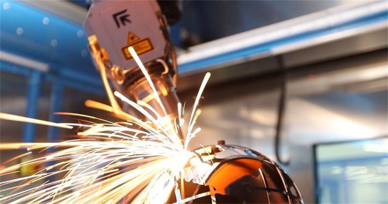 Dynamic 3D Laser Cutting by Prima Power Close-up of a Prima fiber laser performing 3D cutting on a spherical metal object