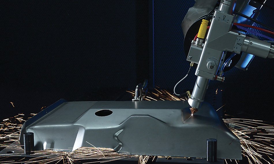 Coherent 3D fiber laser cutter in operation, precisely cutting a metal component.