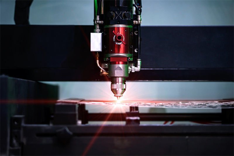 CO2 laser cutting machine in action, cutting a metal sheet