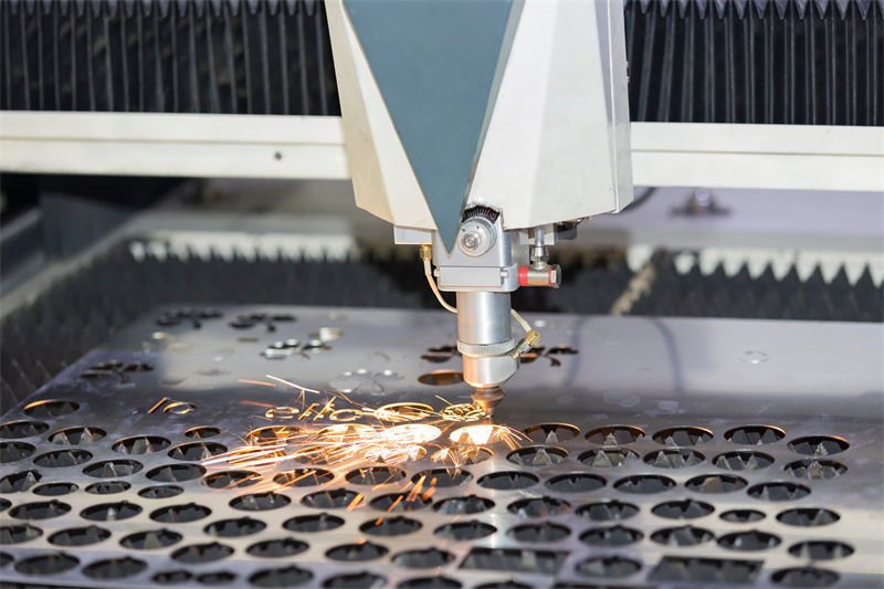 Efficient Laser Cutting of Galvanized Sheet A laser cutting machine efficiently slices through a galvanized sheet, emitting bright sparks