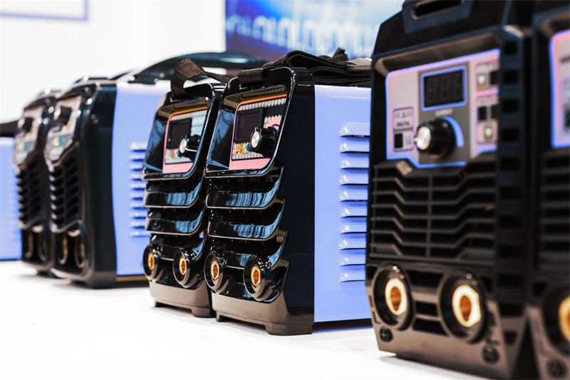 A row of modern welding machines displayed in a professional setting, emphasizing design and functionality