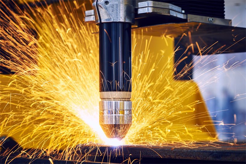 A plasma cutter emitting intense sparks while cutting through metal