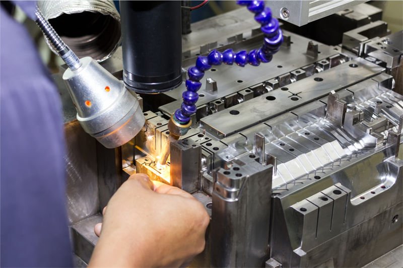 Laser welding being applied to precision molds in an industrial setting