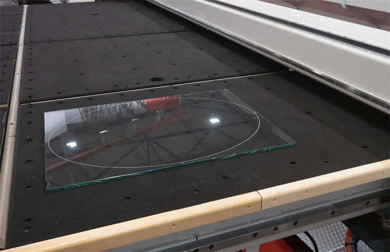 Laser cutting machine processing a glass sheet