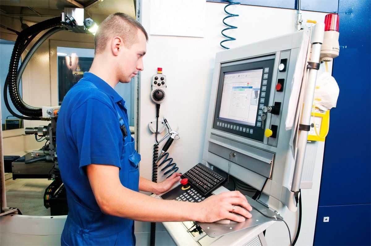 A technician operating a CNC milling machine via a digital control interface to ensure precision in machining tasks